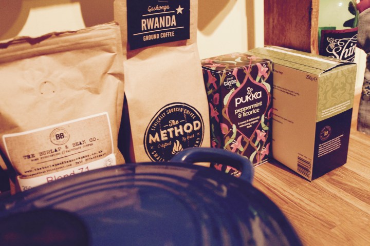 Tea and coffee displayed on wooden bench with Le Creuset cookwear