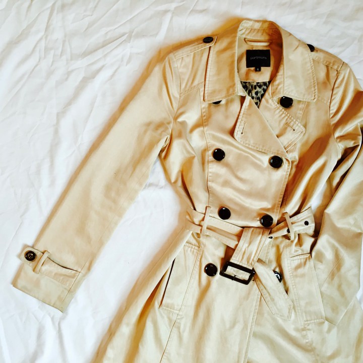 Flat lay of a camel trench coat.