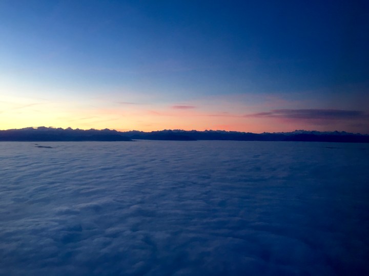 Sunrise aboard a plane flying over Switzerland.
