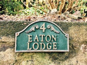 'Eaton Lodge' name plaque in front of English house