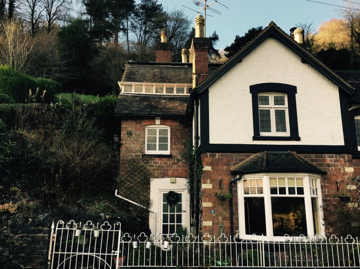 Cottage with white fence nestled into the Malvern Hills, Worcestershire.