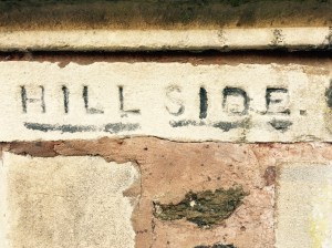 'Hill Side' name etched into sandstone pillar outside English house