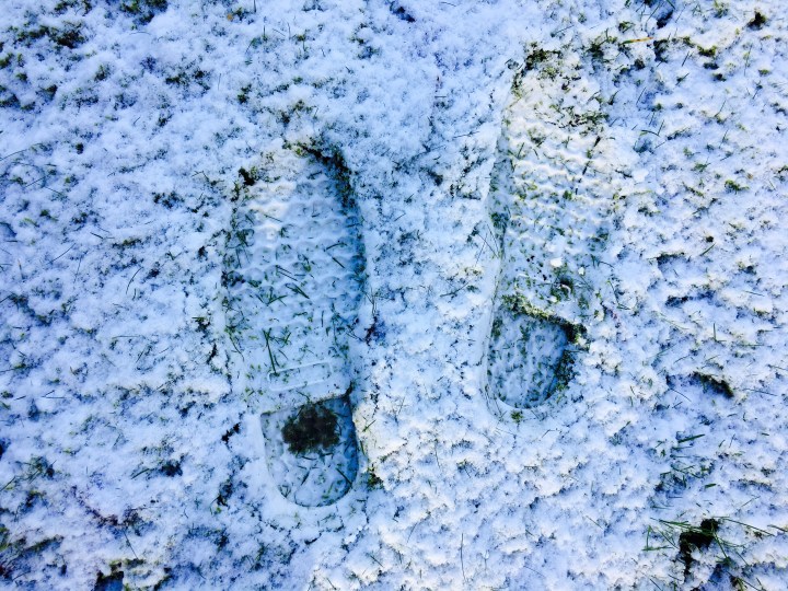 The imprint of LL Bean Boots in the snowy ground.