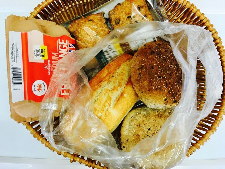Basket of scones, bread rolls and eggs.