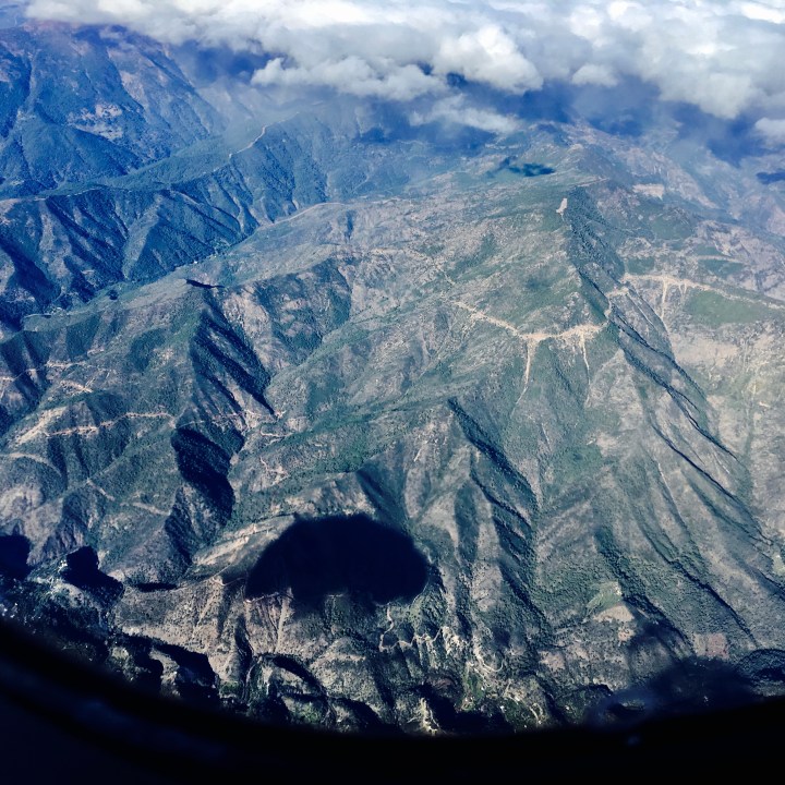 View of mountains in Spain from the window seat of an airplane.