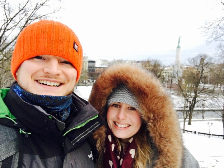 Couple rugged up in winter clothes standing in central Riga, Latvia.
