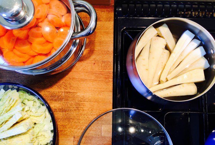 Parsnips, carrots and cabbage being prepared for a roast dinner.
