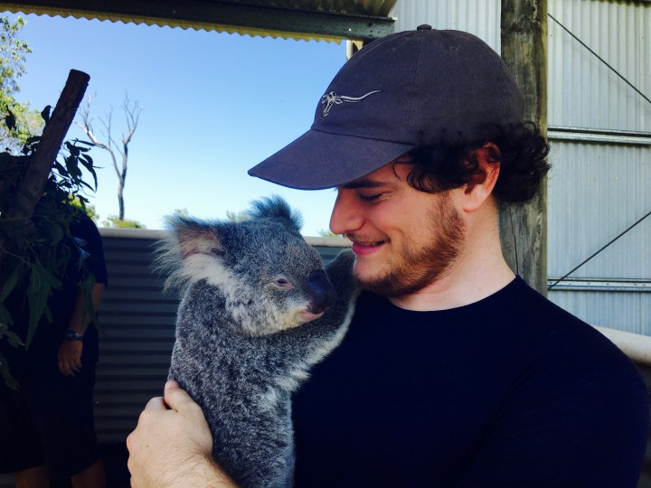 Man holding koala.