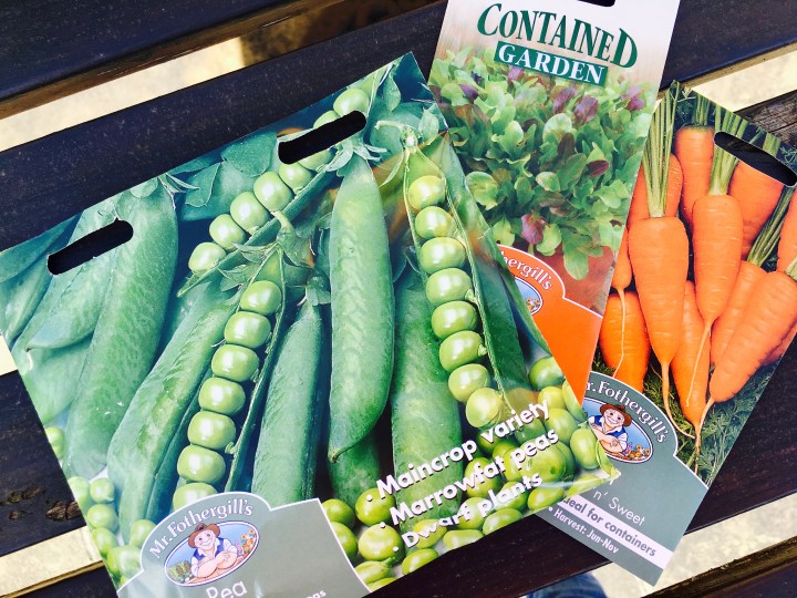 Seed packets for peas, salad leaves and carrots.