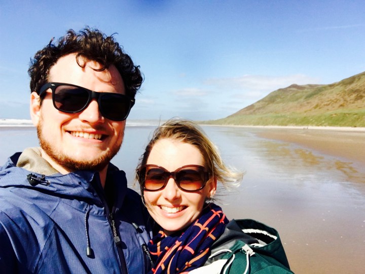 Couple on Rhossili Beach, Gower Peninsula, Wales.