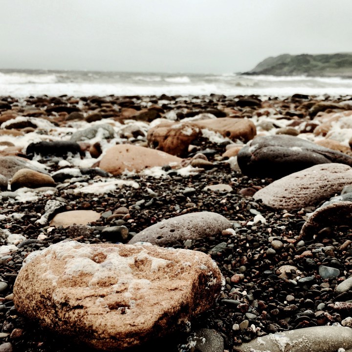 The stone filled beach at Port Mary, Dumfries and Galloway, Scotland.