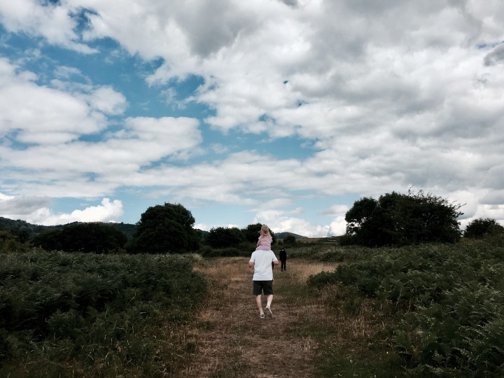 Grandfather carrying grand daughter on shoulders