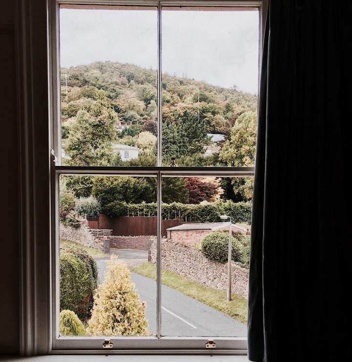 Looking out of a window towards the Malvern Hills in Worcestershire, England.