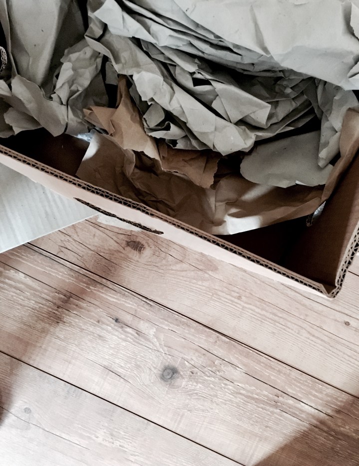 Moving boxes sitting on a wooden floor.