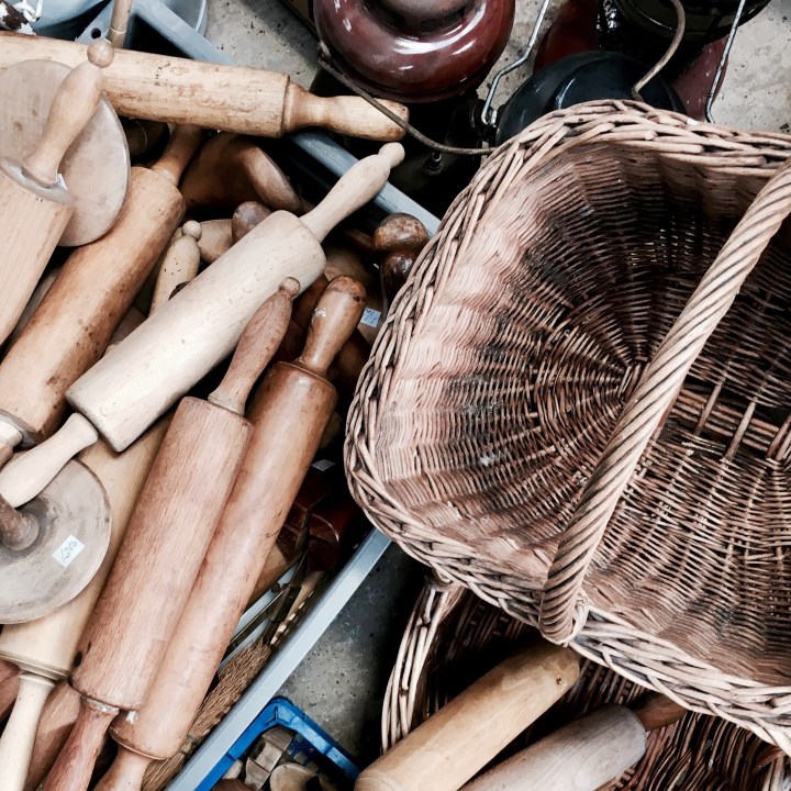 Wooden rolling pins and and a basket at a flea fair in Worcestershire, England.