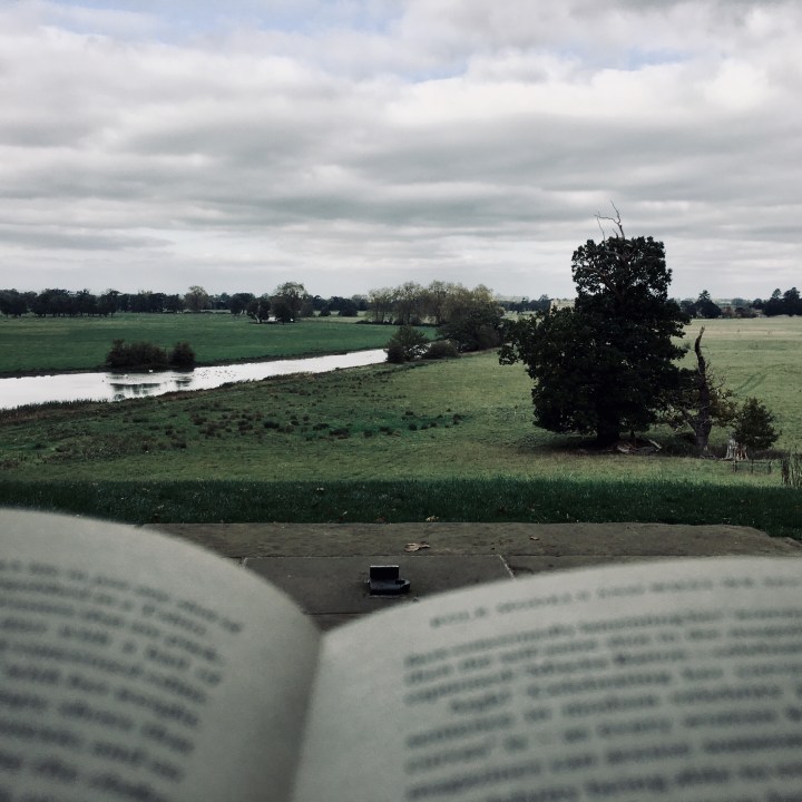 Peering over the top of a book onto the Croome Park estate in Worcestershire, England.