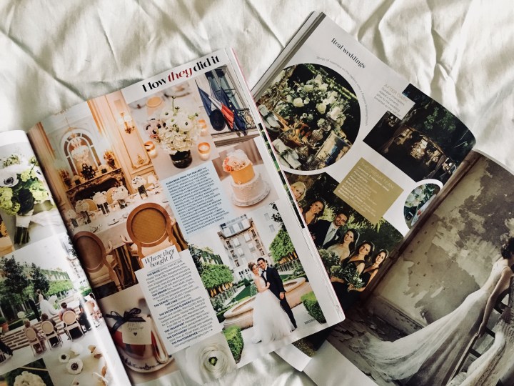 Wedding magazines laying open on an ivory sheet
