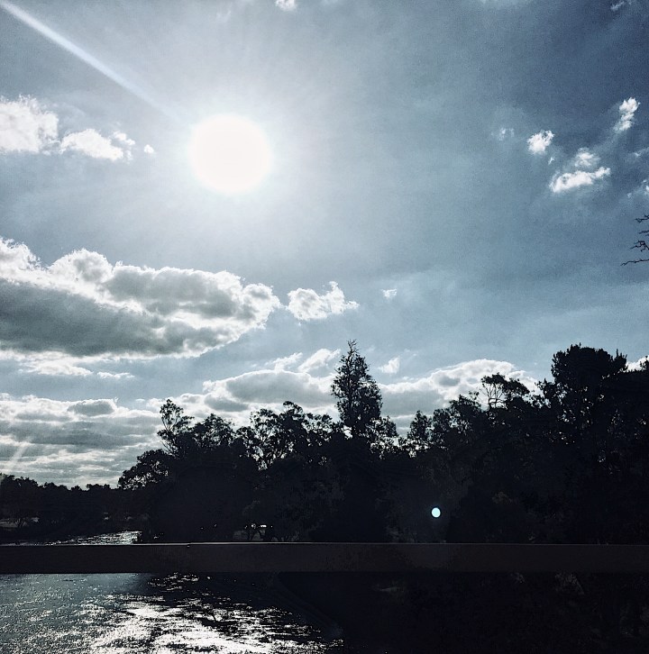 Bright sun shining down on Murrumbidgee River at Wagga Wagga, NSW, Australia.
