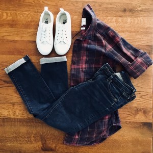 Dark blue jeans, navy and burgundy check shirt and white sneakers.