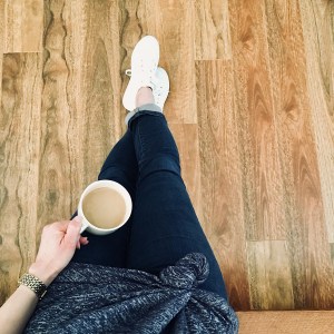 Navy blue dress (worn as a top), dark blue jeans and white sneakers.
