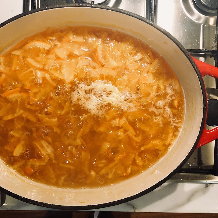 Marmalade bubbling on a gas hob.