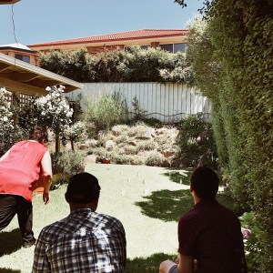 Group of people playing lawn games.