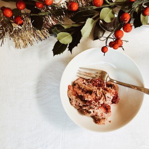 Bowl of Italian summer pudding and Christmas table decorations.