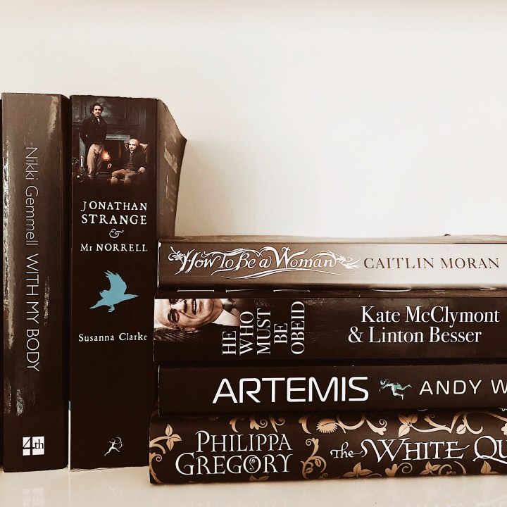 Books with black covers stacked together.