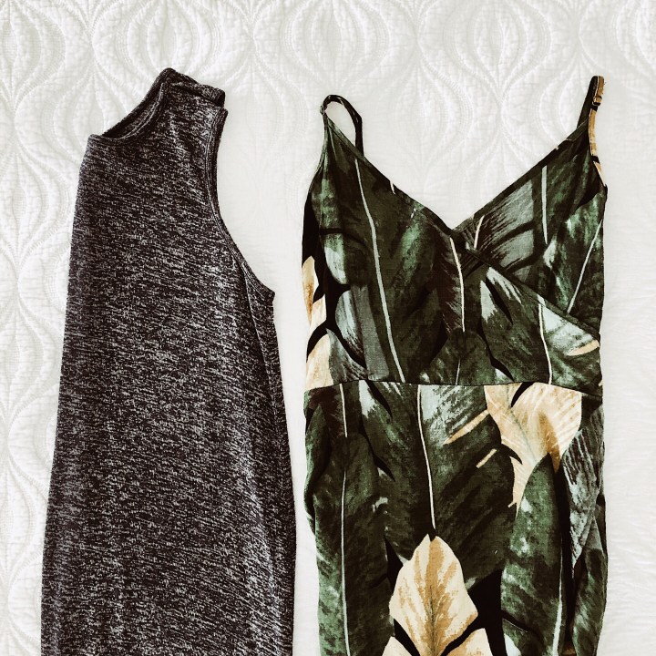 Flat lay of navy t-shirt dress and green and black summer dress.