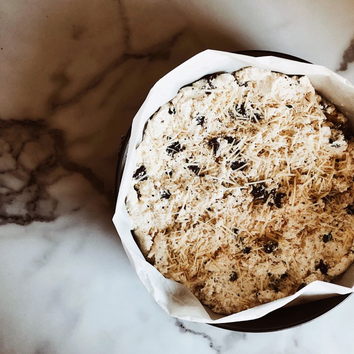 Baked ricotta with olives in a springform tin.