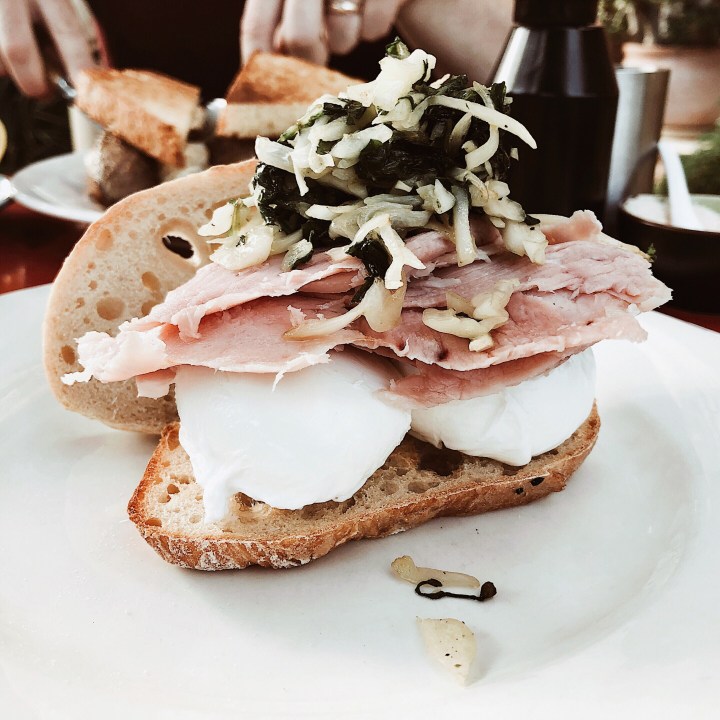 Poached eggs, hand carved ham and sauteed greens.