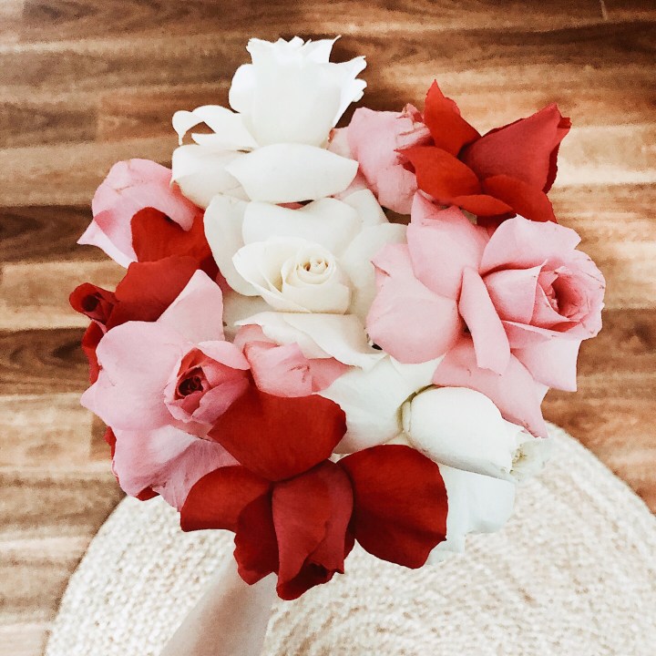 Looking down on a bunch of pink, white and red roses.