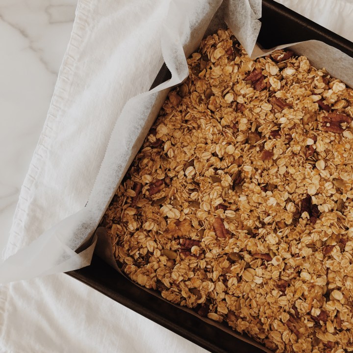 Raw orange and cranberry granola ready to go into an oven to be baked.