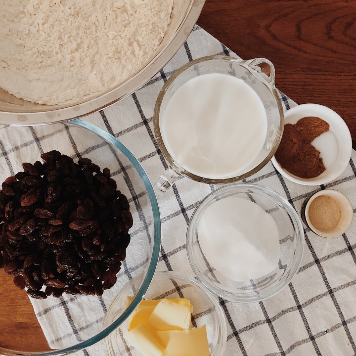 Hot cross bun ingredients on a wooden table.