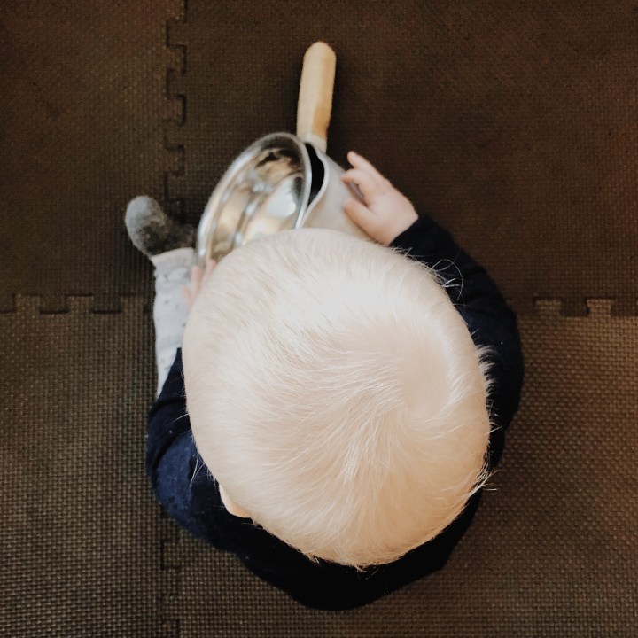 Baby boy playing with pots and pans.
