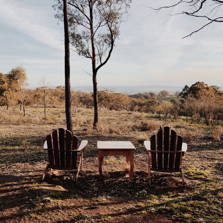 Wooden chairs set up at a lookout at Hillside Airbnb property near Gundaroo, New South Wales, Australia.