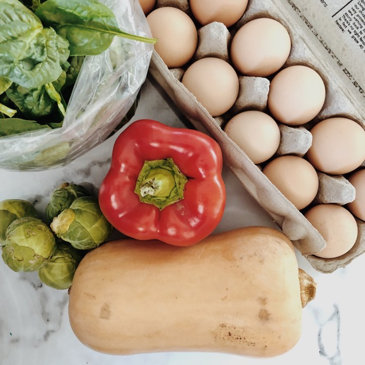 Eggs, spinach, capsicum, Brussels sprouts and a pumpkin.