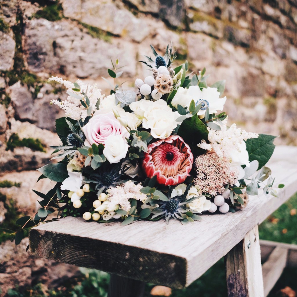 Wedding bouquet on a wooden bench at Lyde Court, Hereford, United Kingdom.