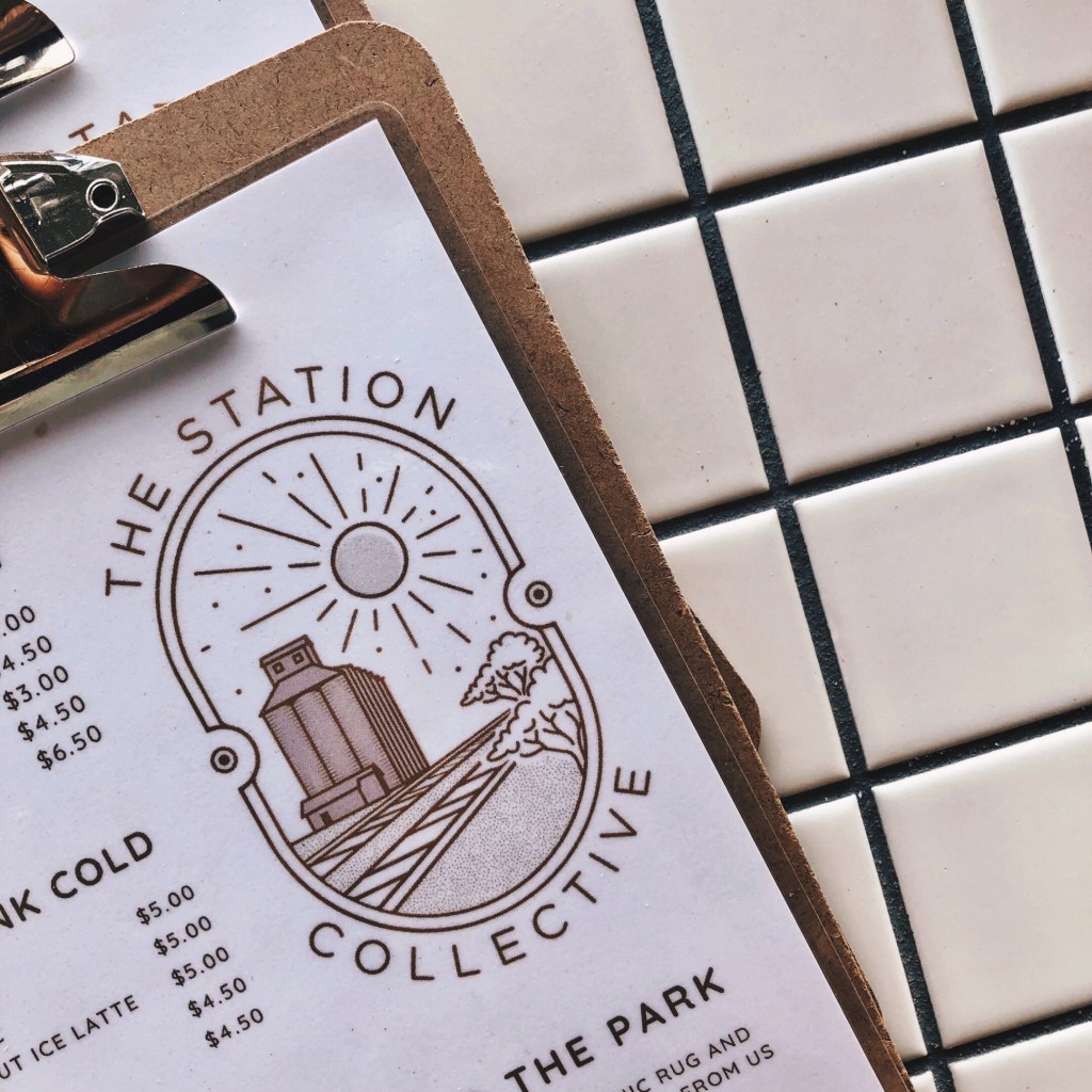 The Station Collective logo on its menu.