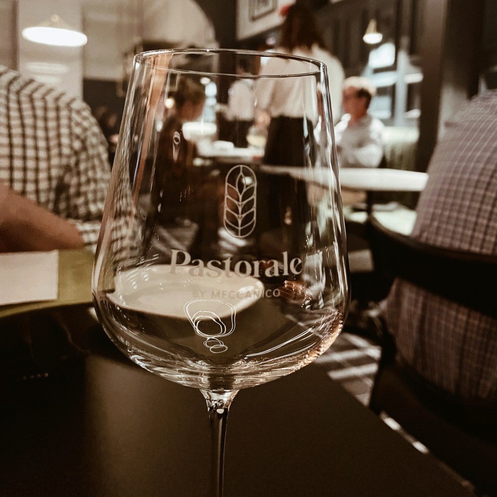 Looking through a wine glass to restaurant Pastorale in Wagga Wagga, New South Wales, Australia.